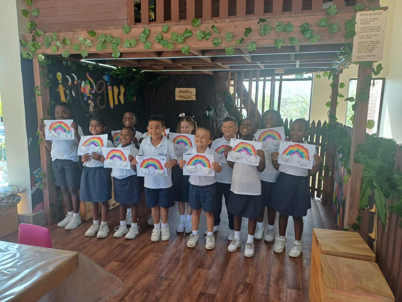 Students with rainbow artwork